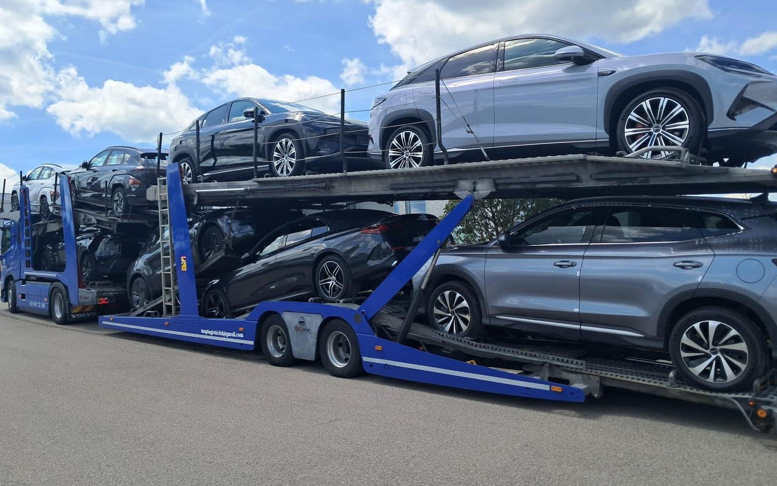 Our blue car transporter loaded with new SUVs on two decks